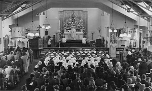 
		A Communion Mass being held in the current Church building.
	